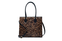 Front view Beverley. Black bovine leather side, back and bottom, with leopard printed hair on hide on the front panel. Contains an inside zipper with a back zip pocket. Bag interior consist of black high quality cotton lining. Top zip closure with gold plated fittings. Comes with a detachable shoulder strap with an adjustable buckle. Bottom panel features bag feet studs.