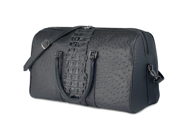 Front side view ostrich leather duffel bag crocodile tail insert. Double zipper, double carry handle, gunmetal hardware. Adjustable detachable shoulder strap. Black suede leather interior, inside zip pocket, two open pockets.