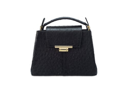 Front view ostrich leather constructed top flap handbag with an Italian lift lock closure. Inside zipper pocket, leather suede interior. Top handle 24 carat gold plated hardware,detachable shoulder strap with adjustable buckle. Bottom feet studs.