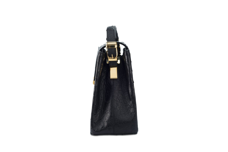 Side view ostrich leather constructed top flap handbag with an Italian lift lock closure. Inside zipper pocket, leather suede interior. Top handle 24 carat gold plated hardware,detachable shoulder strap with adjustable buckle. Bottom feet studs.