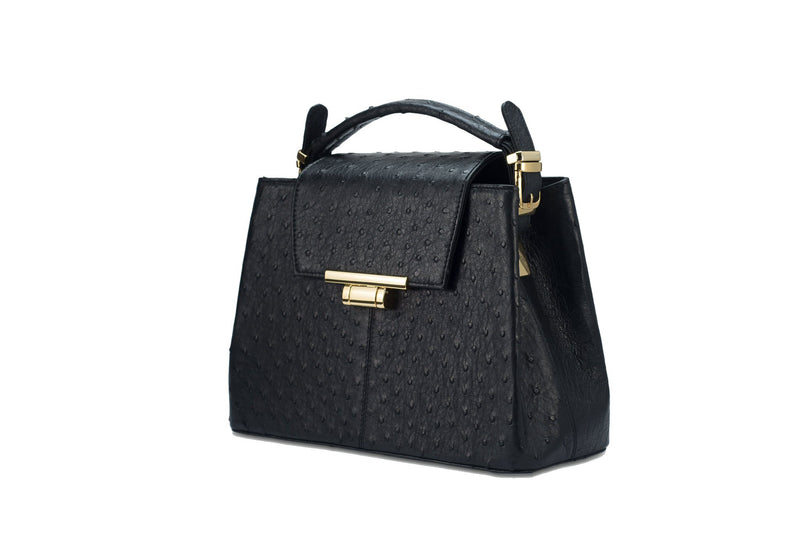 Front side view ostrich leather constructed top flap handbag with an Italian lift lock closure. Inside zipper pocket, leather suede interior. Top handle 24 carat gold plated hardware,detachable shoulder strap with adjustable buckle. Bottom feet studs.