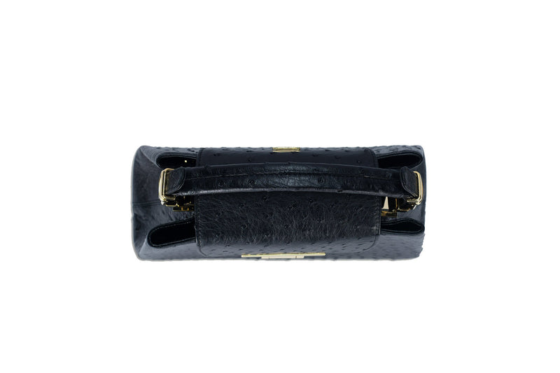Top view ostrich leather constructed top flap handbag with an Italian lift lock closure. Inside zipper pocket, leather suede interior. Top handle 24 carat gold plated hardware,detachable shoulder strap with adjustable buckle. Bottom feet studs.