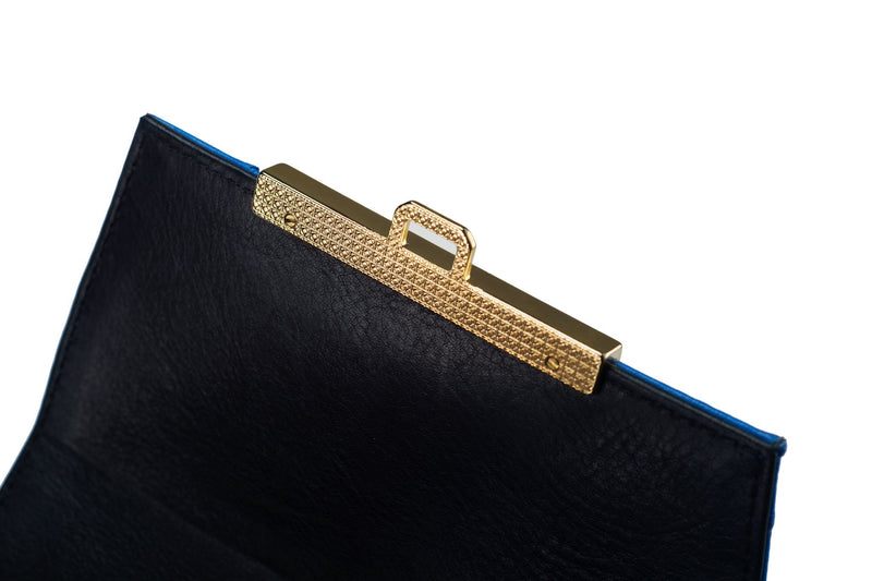 Top flap view ostrich leather constructed top flap handbag with an Italian lift lock closure. Inside zipper pocket, leather suede interior. Top handle 24 carat gold plated hardware,detachable shoulder strap with adjustable buckle. Bottom feet studs.