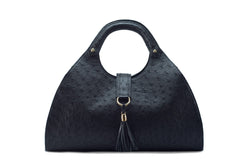 Front view Kimberley black ostrich Leather bag with fold over strap. Hidden magnet with D-ring & tassel decoration for closure. Attached round shaped handles decorated with a studs. Top snap hook closure internal zip pocket with two internal patch pockets. Black high quality suede leather lining, bag feet.