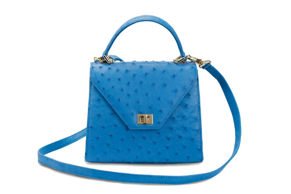 Front view Ostrich leather constructed top flap handbag with an Italian turn-lock closure. Inside zipper pocket, leather suede interior. Top handle 24 carat gold plated hardware,detachable shoulder strap with adjustable buckle. Bottom feet studs.
