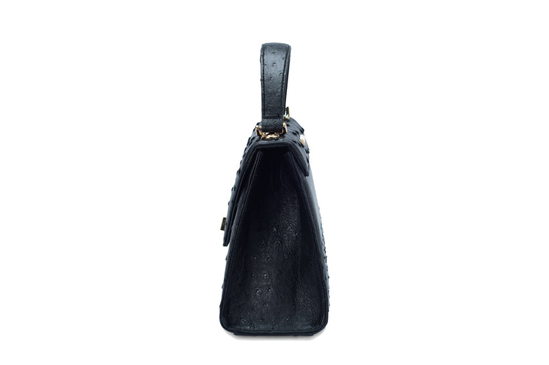 Side view  view Ostrich leather constructed top flap handbag with an Italian turn-lock closure. Inside zipper pocket, leather suede interior. Top handle 24 carat gold plated hardware,detachable shoulder strap with adjustable buckle. Bottom feet studs.