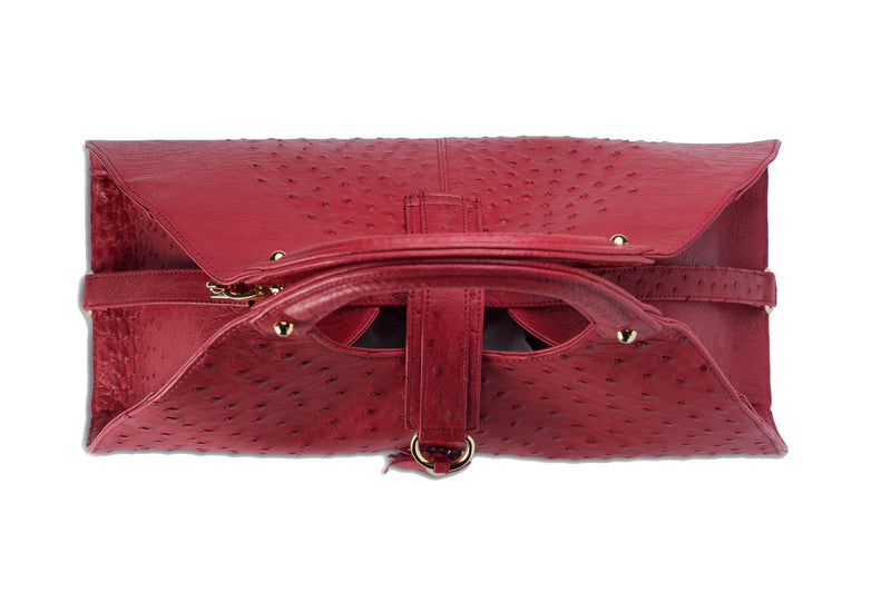 Top view Kimberley red ostrich Leather bag with fold over magnetic strap with D-ring & tassel decoration. Attached round shaped handles decorated with a studs. 