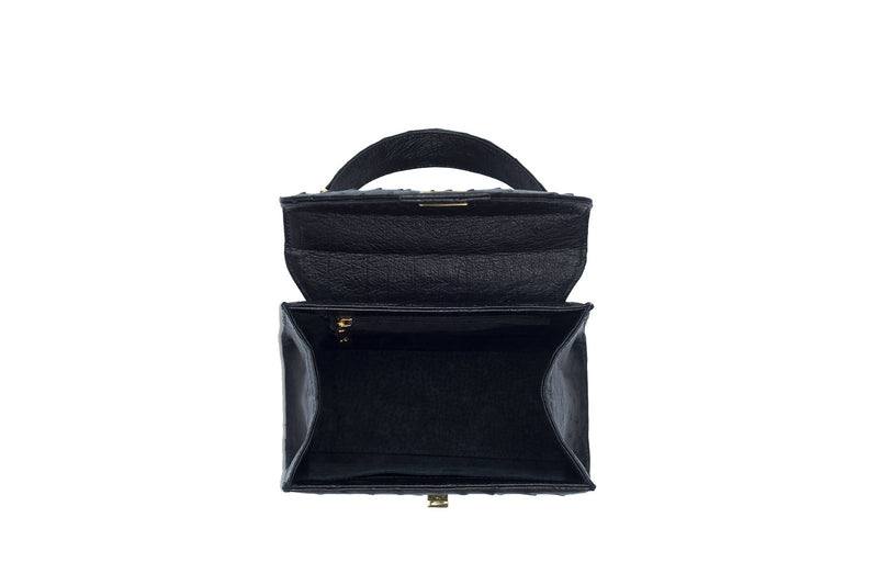 Open top  view Ostrich leather constructed top flap handbag with an Italian turn-lock closure. Inside zipper pocket, leather suede interior. Top handle 24 carat gold plated hardware,detachable shoulder strap with adjustable buckle. Bottom feet studs.
