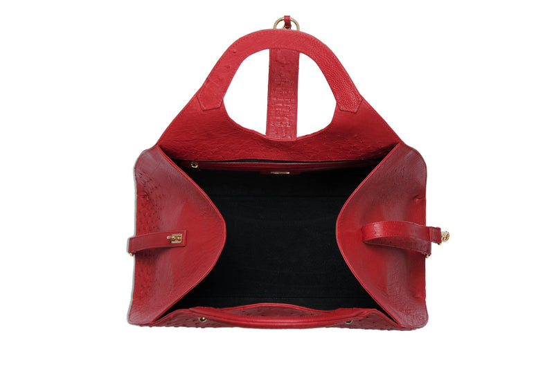 Top open view Kimberley red ostrich Leather bag with fold over magnetic strap with D-ring & tassel decoration. Attached round shaped handles decorated with a studs. 