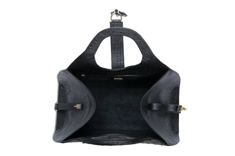 Top open view Kimberley black ostrich Leather bag with fold over strap. Hidden magnet with D-ring & tassel decoration for closure. Attached round shaped handles decorated with a studs. Top snap hook closure internal zip pocket with two internal patch pockets. Black high quality suede leather lining, bag feet.