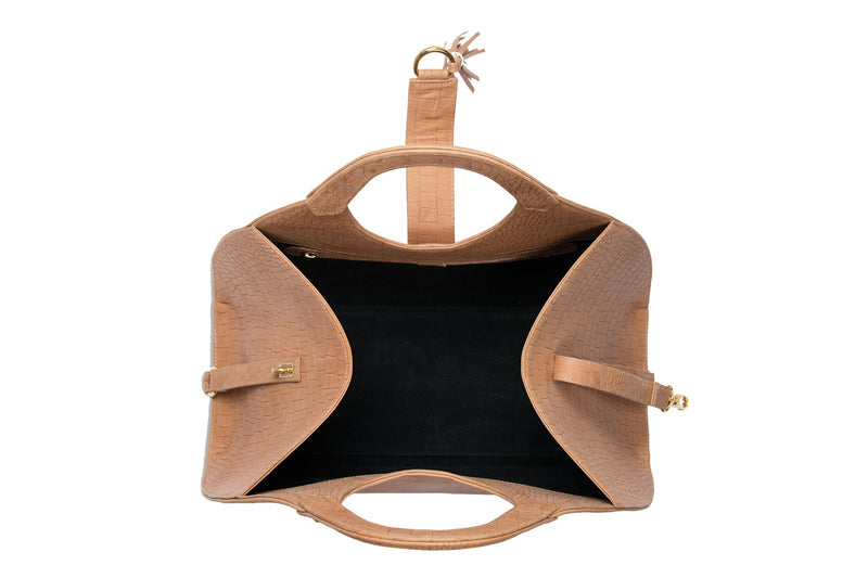 Open top view Leather bag with fold over hidden magnet strap with D-ring & tassel decoration for closure. Attached round shaped handles decorated with two studs. Internal zip pocket with two internal patch pockets. Black high quality leather lining.  Bag feet. 
