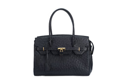 Ostrich leather handbag with top zip. The interior contains an inside zip pocket with two internal patch pockets, and is lined with high quality black suede leather. Features a double handle and a gold lock system as decorative hardware. Bag feet studs are located on the bottom panel of the bag.