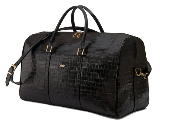 Front side view embossed Crocodile leather duffel bag. Includes a double zipper and double carry handles. Adjustable and detachable shoulder strap. Black suede leather interior, inside zip pocket and two open pockets.